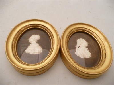 Lot 445 - Two carved ivory portrait silhouettes in oval gilt frames