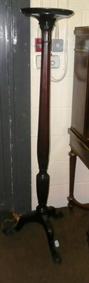 Lot 623 - A carved mahogany tripod torchere