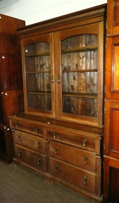 Lot 627 - An oak glazed bookcase over a sideboard base