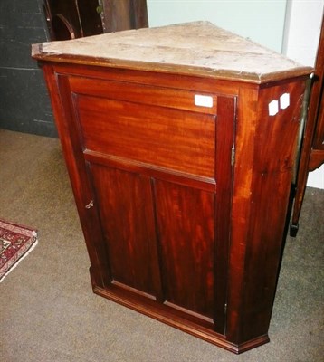 Lot 634 - A mahogany hanging corner cupboard