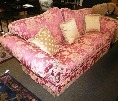 Lot 681 - A red and cream upholstered two seater knoll sofa