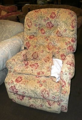 Lot 683 - An upholstered reclining armchair