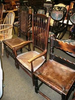 Lot 704 - Spanish style side chair with leather seat, carved oak chair and rush seated chair (3)