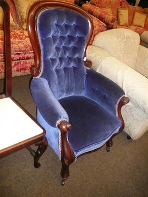 Lot 707 - A Victorian mahogany spoon back armchair with blue velvet upholstery