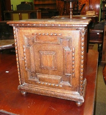 Lot 714 - A 19th century oak spice cabinet with a panelled door