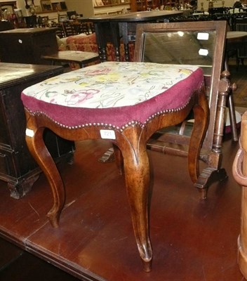 Lot 721 - A walnut framed stool with needlework top and an oak toilet mirror