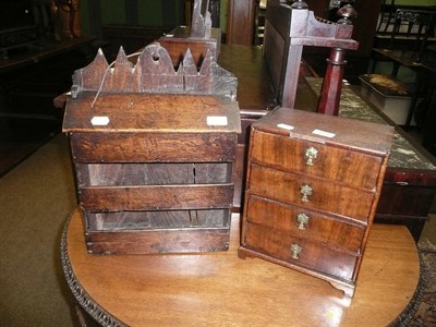 Lot 727 - A 19th century miniature chest of drawers with a secret compartment and an oak small hanging rack