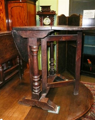 Lot 737 - A 19th century oak drop leaf table