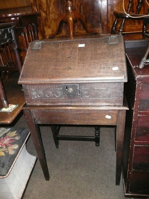 Lot 742 - An oak bible box carved with the date 1663, initialled ET on a later oak stand