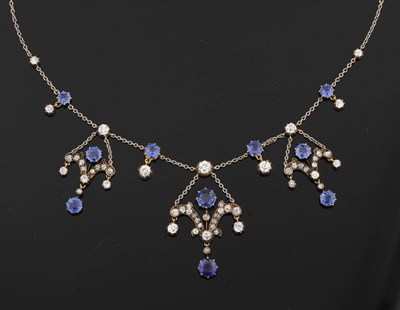 Lot 246 - A Sapphire and Diamond Necklace, circa 1900, three graduated scroll pendants set with sapphires and