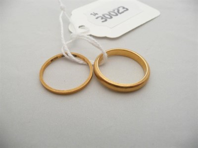 Lot 62 - Two 22 carat gold band rings, 5.5g approx.