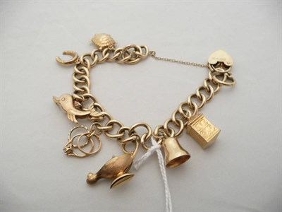 Lot 75 - A 9 carat gold charm bracelet hung with seven charms, 31.9g approx
