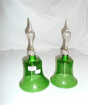 Lot 84 - A pair of Victorian green glass bells with clear handles and original white opaque glass clappers