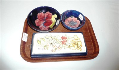 Lot 170 - A Moorcroft "Clematis" bowl, a Moorcroft tray (boxed) and a Moorcroft "Hibiscus" bowl (3)