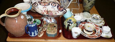 Lot 181 - Two trays of decorative ceramics, including Hummel figures, enamelled boxes, Imari dish, tea...