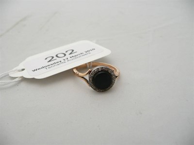 Lot 202 - An onyx and diamond cluster ring stamped '18CT', 3.5g approx.