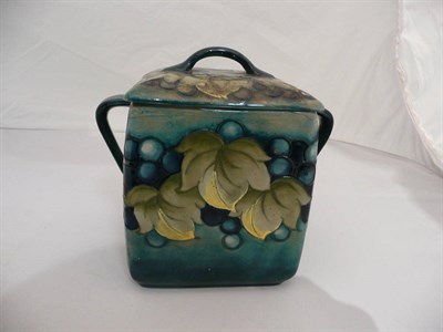 Lot 256 - A William Moorcroft twin handled 'Leaf & Berry' jar and cover (a.f.)