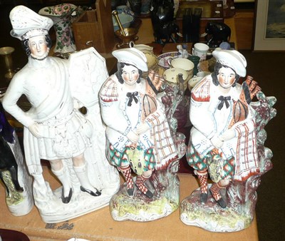 Lot 300 - A titled Staffordshire figure "Rob Roy" and two Staffordshire figures of highlanders (3)