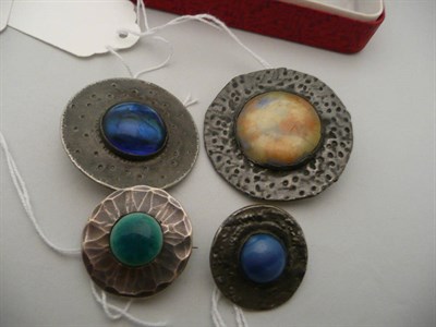 Lot 334 - Four Arts & Crafts pewter and cabochon mounted brooches