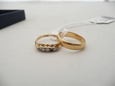 Lot 343 - An 18ct gold band ring, 3.3 grams approx. and a boat shaped diamond five stone ring (one...