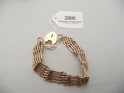 Lot 386 - 9 carat gold gate bracelet and locket