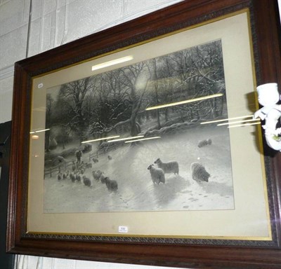 Lot 532 - Print after Farquharson, farmer feeding sheep in winter landscape in an oak frame