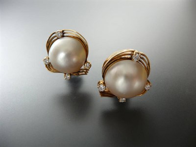 Lot 295 - A Pair of Mabe Pearl and Diamond Earrings, the mabe pearls sit within a scroll border set with...