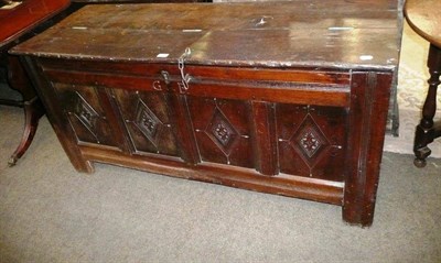 Lot 587 - A heavy oak four panel coffer with lozenge moulded front