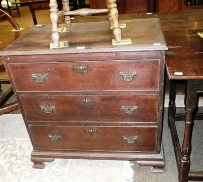 Lot 596 - A George III small oak three height chest with brushing slide