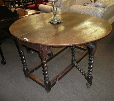 Lot 599 - An oak barley twist gate leg table