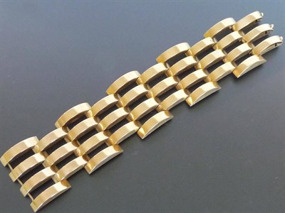 Lot 301 - A Heavy Gate Bracelet, the hollow domed links in plain polished yellow gold, measures 19cm in...