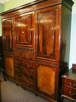 Lot 670 - Early 20th century mahogany four piece bedroom suite - a combination wardrobe, dressing table,...