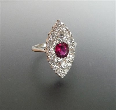 Lot 307 - A Ruby and Diamond Navette Cluster Ring, the cushion cut ruby surrounded by pavé set old cut...