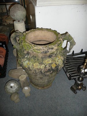 Lot 821 - A vine-decorated twin-handled garden urn