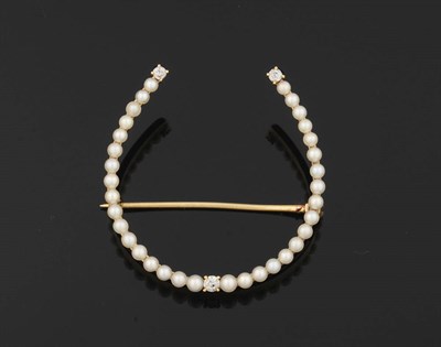 Lot 321 - A Seed Pearl and Diamond Horseshoe Brooch, a line of slightly graduating seed pearls is set...