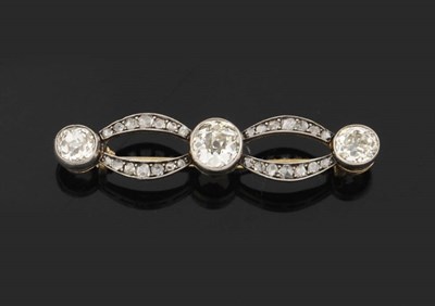 Lot 322 - An Edwardian Diamond Brooch, three graduated old cut diamonds are spaced by diamond set loops,...