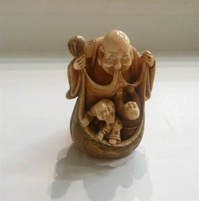 Lot 11 - A Japanese ivory okimono of Hotei and two boys in a sack, circa 1930