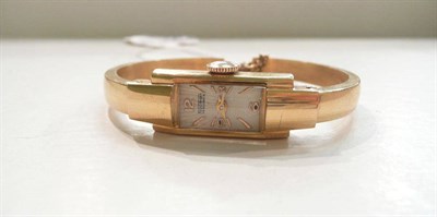 Lot 35 - A lady's bangle wristwatch stamped 18k, by Fischer