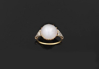 Lot 325 - An Edwardian Star Sapphire and Diamond Ring, the star sapphire held in a yellow claw setting,...