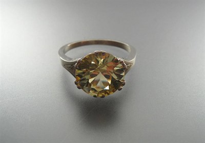 Lot 326 - A Yellow Sapphire Solitaire Ring, the round brilliant cut pale yellow stone in a white double...