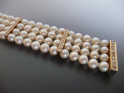 Lot 327 - A Cultured Pearl and Diamond Bracelet, four rows of knotted cultured pearls are spaced by...