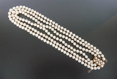 Lot 328 - A Graduated Three Row Cultured Pearl Necklace, the three rows strung to an oblong clasp set...