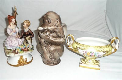 Lot 75 - A Capodimonte figure group, a German monkey jug and a Limoges yellow-ground bowl