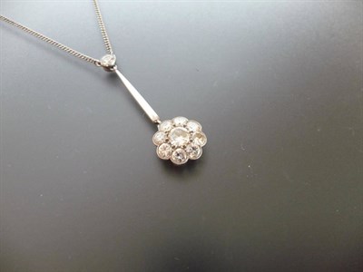 Lot 336 - A Diamond Pendant, a round cut diamond cluster pendant in a white millegrain setting on a...