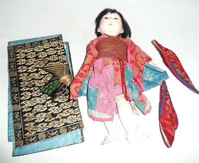 Lot 150 - Oriental doll, pair of Chinese embroidered slippers and three embroidered panels