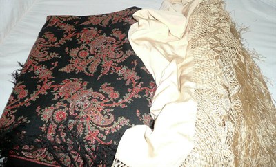 Lot 151 - Victorian woven paisley shawl and a cream silk shawl with fringing (2)