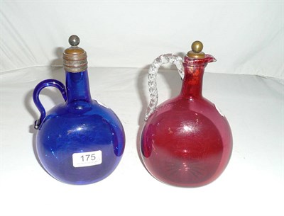 Lot 175 - Two late Victorian glass flagons in blue and cranberry