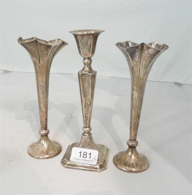 Lot 181 - A pair of silver spill vases and a silver candlestick