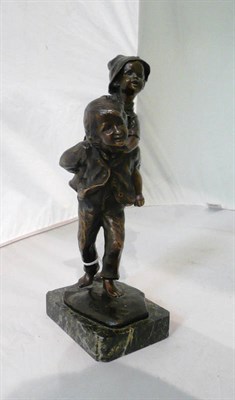 Lot 182 - A bronze figure of a young boy carrying a child