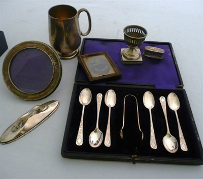 Lot 191 - A silver mug, cased silver teaspoons, small silver photo frame, etc